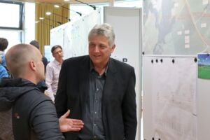 Zwei Personen unterhalten sich vor einer Papierkarte
